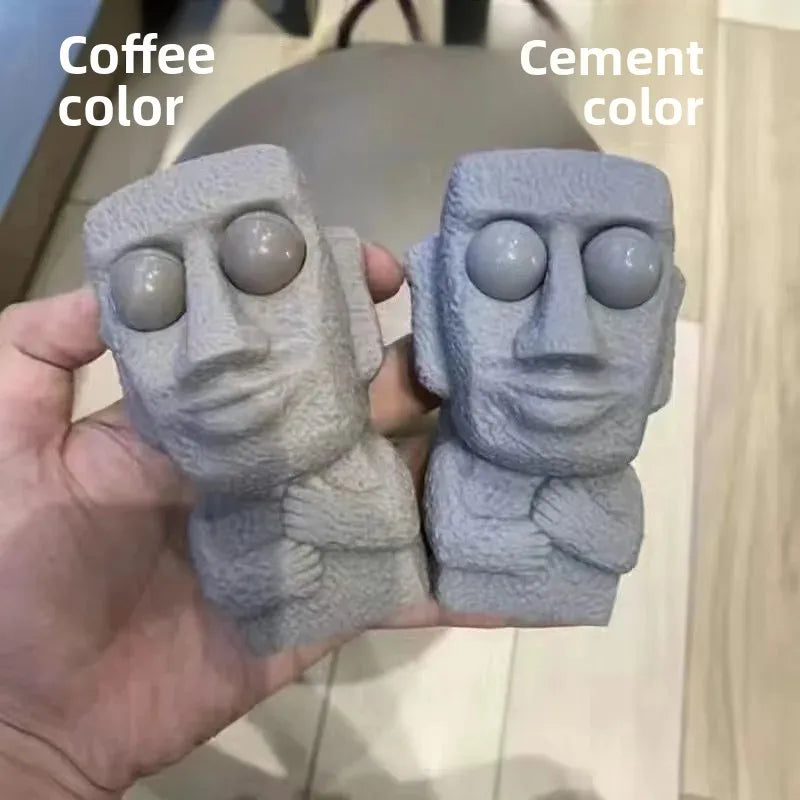 Stone man releases stress toy slowly rebounds soft Moai statue squeeze eyes interested expression relaxes stress children's gift