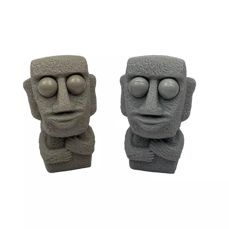 Stone man releases stress toy slowly rebounds soft Moai statue squeeze eyes interested expression relaxes stress children's gift