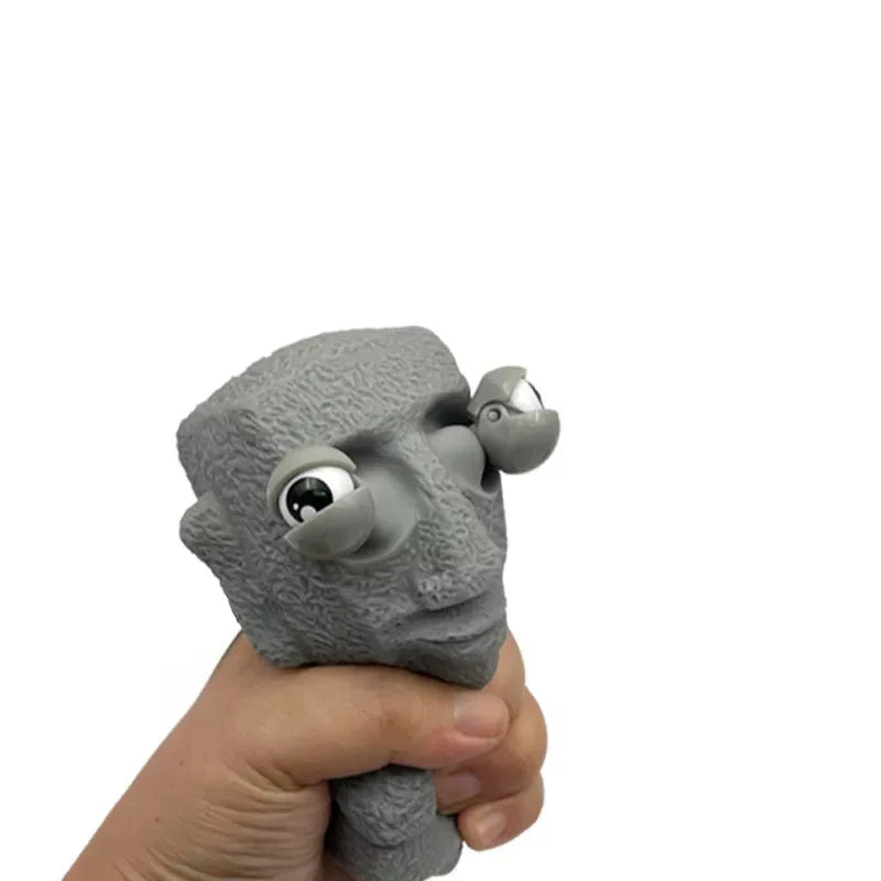 Stone man releases stress toy slowly rebounds soft Moai statue squeeze eyes interested expression relaxes stress children's gift